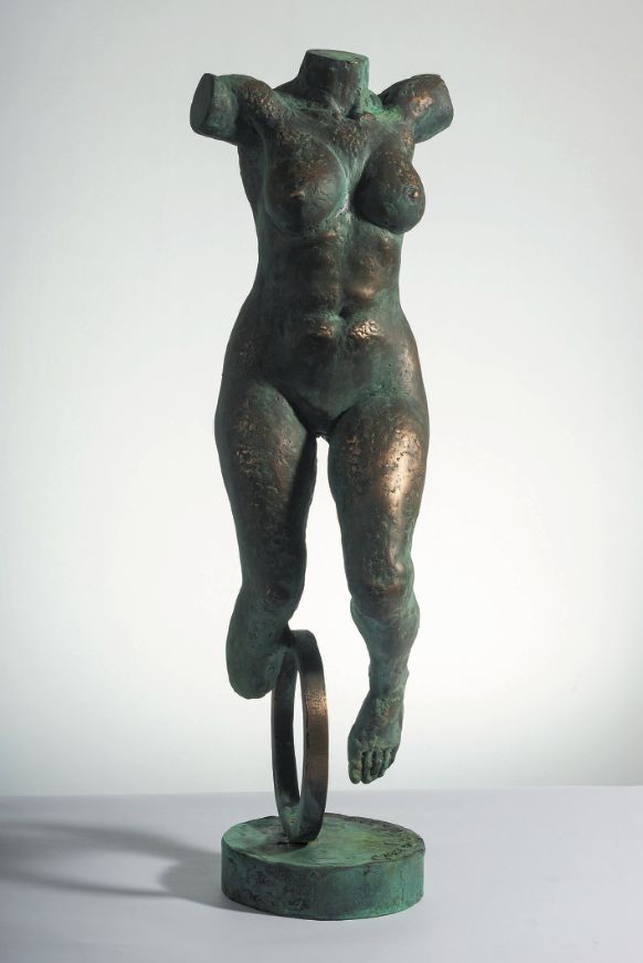 Bronze sculpture “Lady from Amsterdam”: a headless female torso with short arms, balancing on one leg above a metal ring, on a round base.