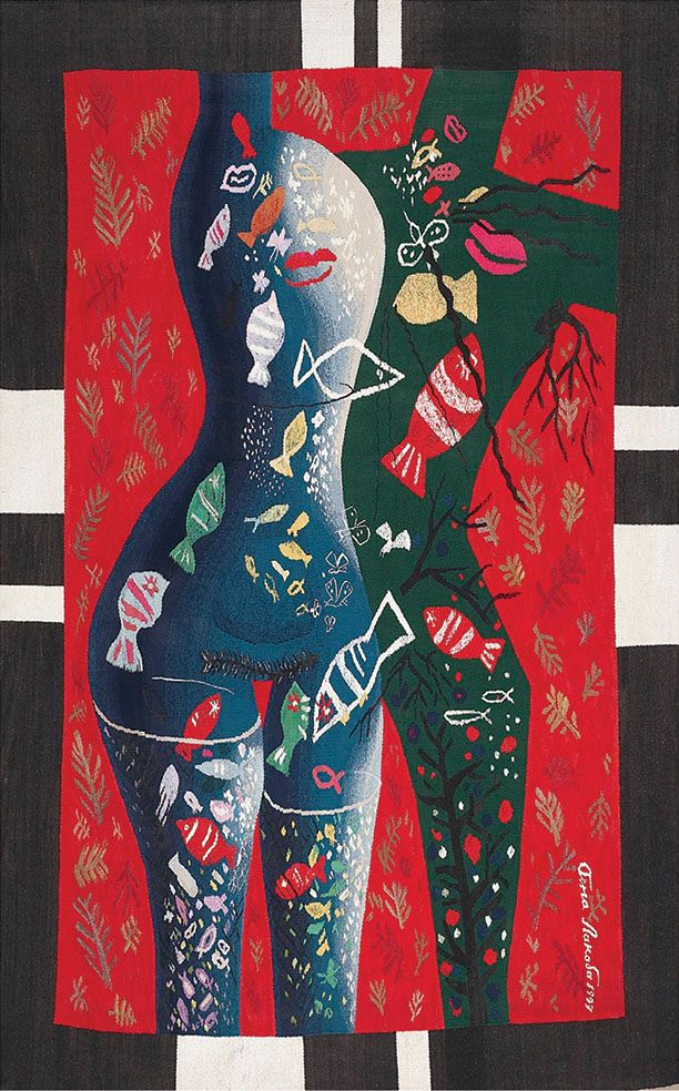 Tapestry “Lake”: a tall nude female figure in blue and green, filled with colourful fish, on a red ground with leaf patterns and a black and white border.