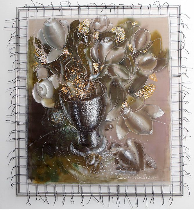 Silk painting “Magnolias in a crystal vase”: grey-white magnolia flowers with gold-flecked buds in a dark stemmed vase, with shells below, stretched in a metal frame.