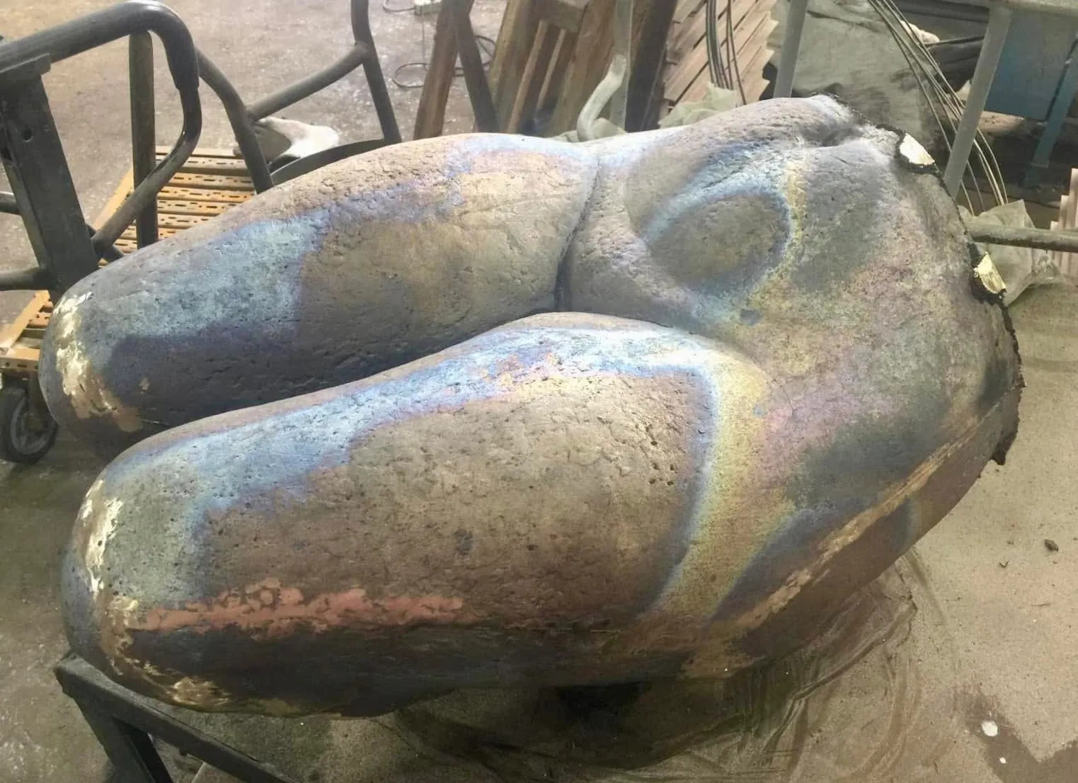 Cast bronze torso and legs with iridescent oxidised surface, in the foundry