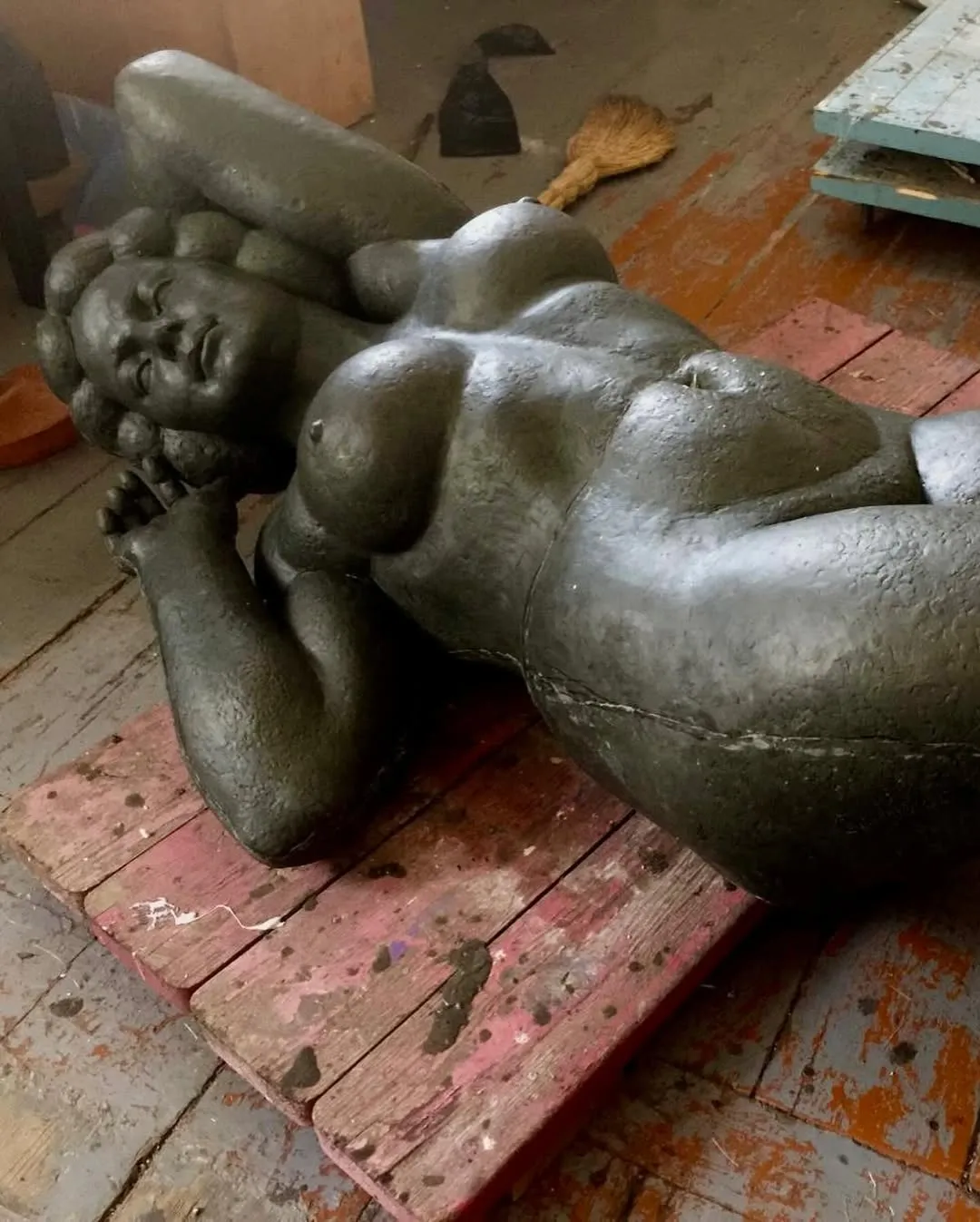 Margo in plasticine: the figure lying on a painted wooden pallet on the studio floor