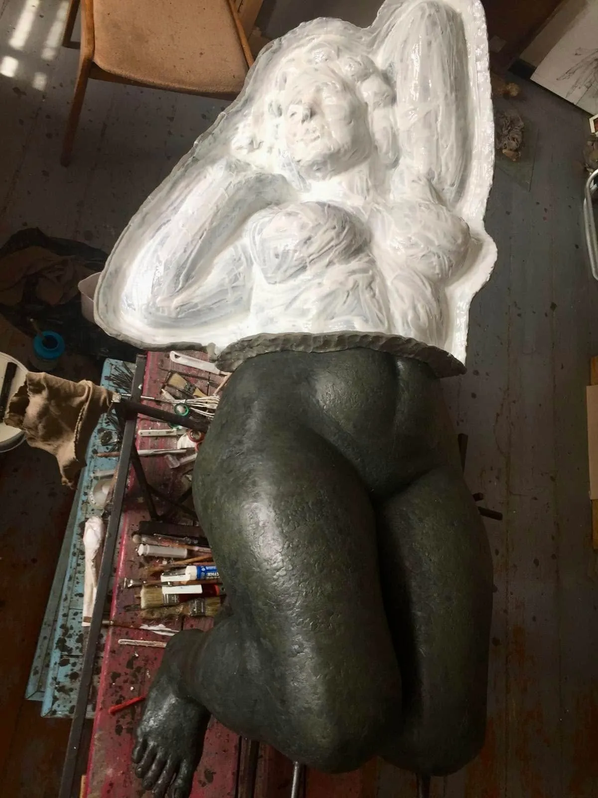 White mould section above the lower half of the figure, with legs and a foot visible