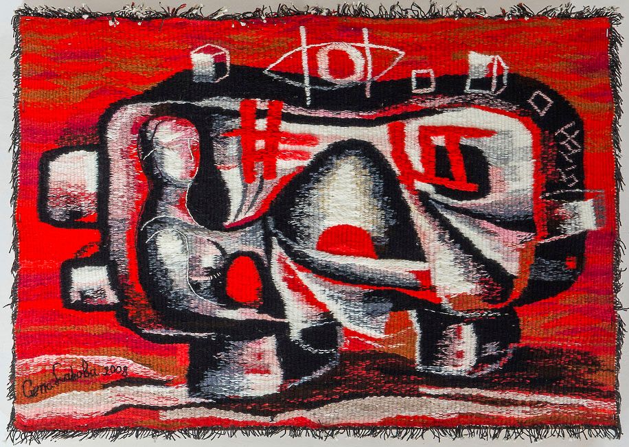 Tapestry “Red dolmen”: a pale seated female figure inside a dark, rounded form with small cubes, on a bright red woven background.